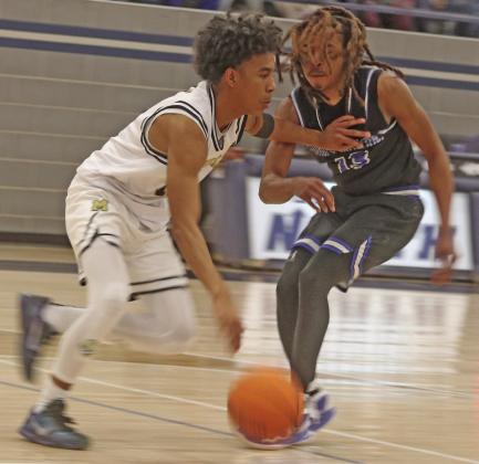 Braydon Morgan plays some tight defense against Midwest City.