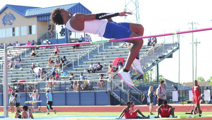 Kaiden Ballard Stevenson clears high jump bar.