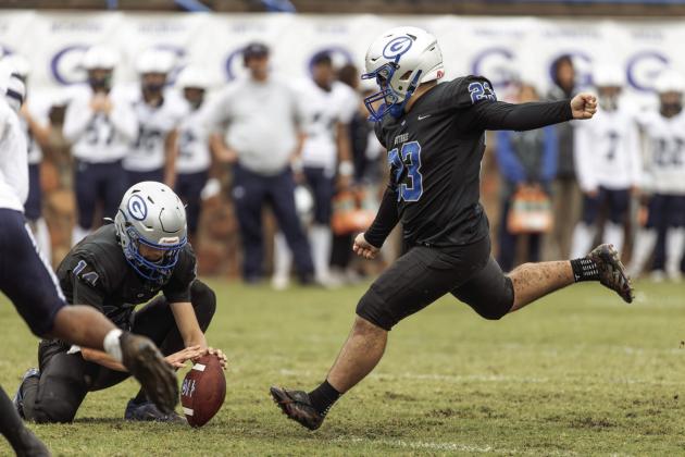 Guthrie kicker Ceasar Lopez attempts an extra point against Altus as Daelon Rice holds. The Bluejays came from behind to win.