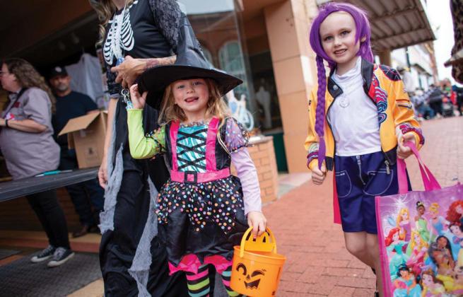 Children dressed in costumes make their way down Oklahoma Avenue during Guthrie’s annual trick-or-treat event on Halloween night.