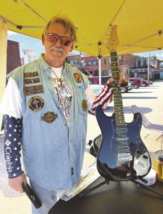 Greg Gibson-Bailey with one of his Gregenstein guitars (All proceeds from raffle tickets go to Guthrie Band Boosters).