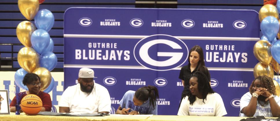 Pictured above, Guthrie Senior Ania Morgan signs a Letter of Intent to play basketball next year at Tabor College in Kansas. Family, Friends and teammates were present for the signing on April_ . Photo by Mike Monahan