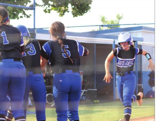 Elaina Clark greeted at home aftersecond inning home run