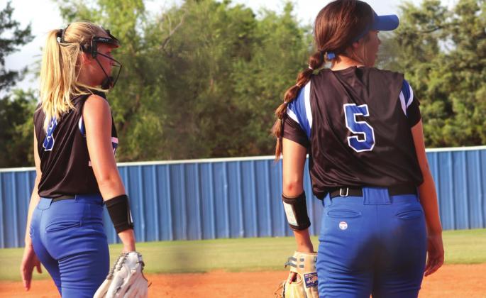 Kinley Duehning and Eadie Jobe check out play at first base