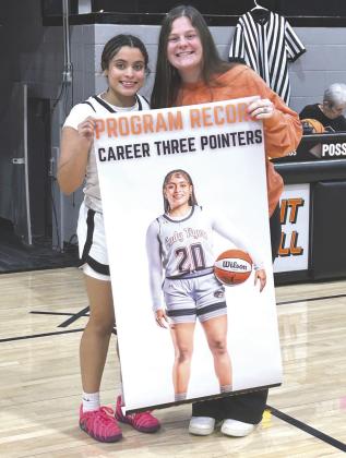Crescent basketball player Aja Adams-House, who tied a program record with the 118th 3-point basket of her career in a homecoming win over Watonga. Previous record holder Katie Howell presented Adams-House with a commemorative banner. Submitted photo