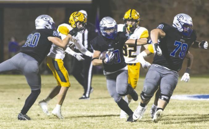 Zane Thomas direct trffic as Chase Doles and Cooper Walters provide the blocking.