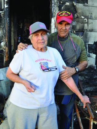 Joyce &amp; Ray in front of what was left of their home.