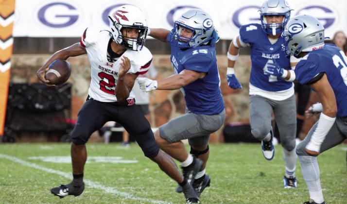 Guthrie defender Rowan Mchone attempts to tackle Duncan's CJ Warner during the Bluejays' 42-10 win Sept. 12.
