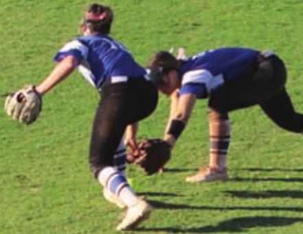 Elaina Clark and Ava Hebensperger go for ball in outfield