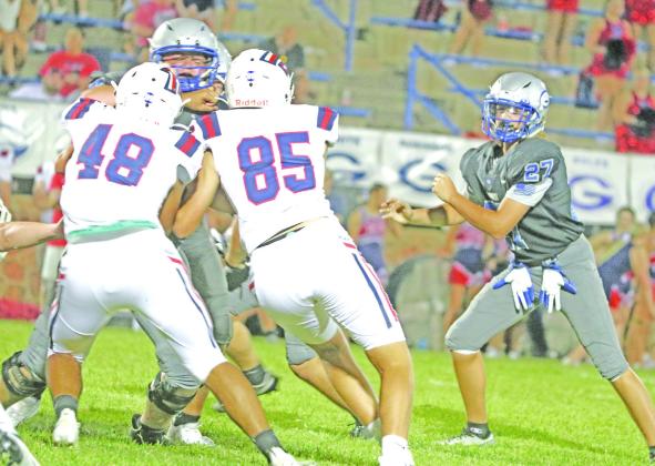 Guthrie_s Zane Thomas is corralled by Ponca City_sAntwan Railback (48) and Jackson Hunt (85) as Maddox Vaughn (27 looks on for Guthrie.