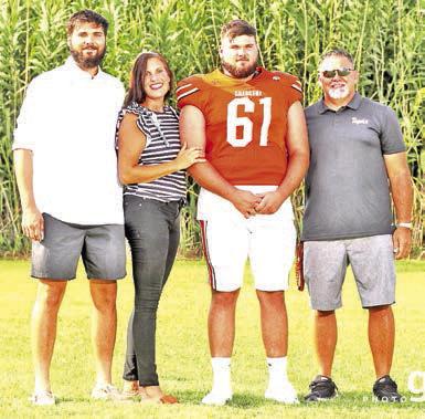 From left: Trent Fisher, Jennifer Fisher, Stone Fisher and Head Coach JL Fisher at Tiger Stadium.