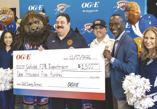 Thunder Girl Tamia Piazza, Rumble, Guthrie Fire and EMS Captain Ryan Reeves, Chief Dane Lausen, OG&amp;E Community Affairs Manager Spencer Browne, and Thunder Girl Zoey Taylor pose during a ceremony honoring Reeves’ commitment to public safety. Reeves was also presented a $1,500 check to the Guthrie Fire Department as part of the OG&amp;E Safety Partner Award. Photo courtesy of City of Guthrie