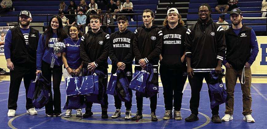 Pictured Above, Guthrie Wrestling Head Coach Jadon Davenport with seniors. Zhania Bryan, Khaleah Kirk, Braden Hall, Eli Kirk, Allyn Orndorff, Waylon Castle, Tikori (TK) Pierce, and Assistant Coach Jeromy Davenport. Photo by Mike Monahan