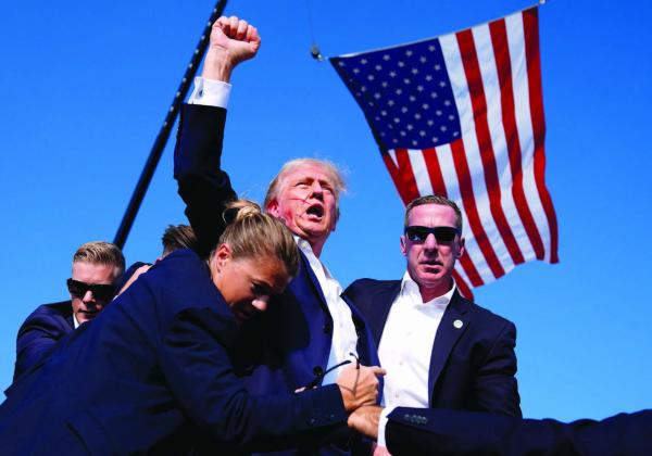 Republican presidential candidate former President Donald Trump is surrounded by U.S. Secret Service agents at a campaign rally, Saturday, July __, in Butler, Pa. ( AP Photo/Evan Vucci)
