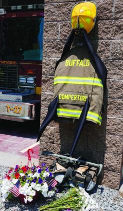 Flowers and a tribute to fallen firefighter Corey Comperatore are pictured at the Buffalo Township Volunteer Fire Company in Buffalo Township, Pa., Monday, July 15, 2024, Comperatore was shot and killed at the Trump rally in Butler, Pa., Saturday, July 13, 2024 (AP Photo/ Sue Ogrocki)