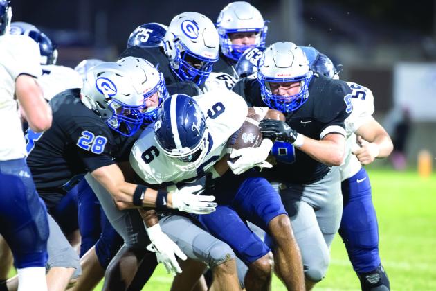 A host of Guthrie defenders take down an El Reno ball carrier during the Bluejays’ 42-0 win on Oct. 10 at Jelsma Stadium. The Guthrie defense limited the Indians to 50 yards of offense, including 15 yards through the air.
