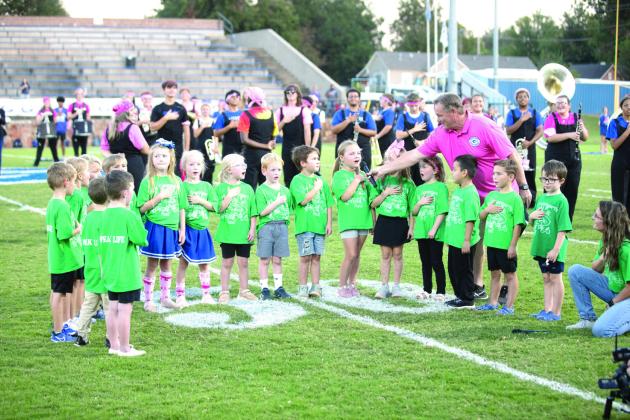 Mrs. Davenports Kindergarten class kicked off Friday’s game by leading the National Anthem.