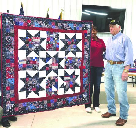 Handmade quilt presented to Veteran Jan Goodyear by the Quilts of Honor