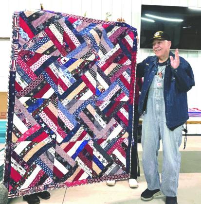 Handmade quilt presented to Veteran Joe Blair by the Quilts of Honor