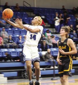 Coyle’s Miguel Howell drives to the basket ahead of Panthers Joe Hermann.