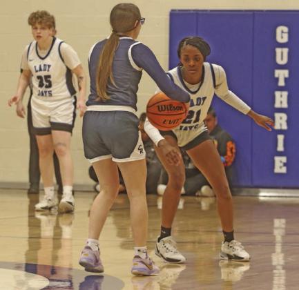 Ania Morgan and Denise Doolittle look to stop El Reno offense.