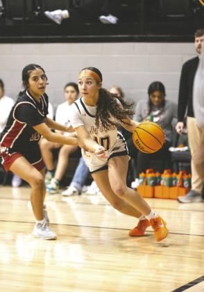 Crescent sophomore Trinity Webster drives past a Watonga defender during the Tigers’ 72-51 homecoming win. Photo by Brent Fuchs