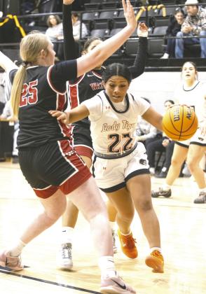 Lady Tiger Zori Wilson dribbles around a Watonga defender during Crescent’s homecoming win. Photo by Brent Fuchs