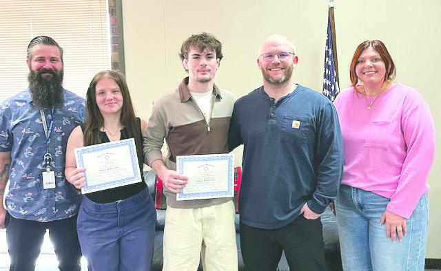 Pictured with the students is Levi Casey, girls wrestling coach, Jadon Davenport, boys wrestling coach and Rotary President, Coy McPeek.