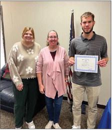 Pictured with Isaiah is Rotary President, Coy McPeek and Heidi Mallow, Director of Engagement with God’s Food Bank.