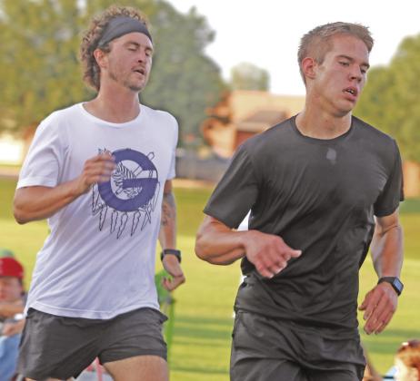 ABOVE - Junior High Girls at Guthrie Mile Night. LEFT - Isaiah Blevins edges Coach in Guthrie Boys Mile race.