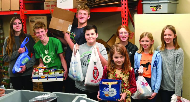 The Logan County 4H Teens took on the Community Service Project to run a food drive for the Hands of Jesus Food Bank. 4H Teens and a few other 4H members dropped off the collected donations. Pictured left to right in back: Audrey Allen (Vice President of Programs), Jimmy Ferguson (co- Recreational Leader), Bobby Ferguson (President), Luke Allen, Lyndi Ward, Daisi Ward, Gracie Ferguson Front: Maggie Ferguson