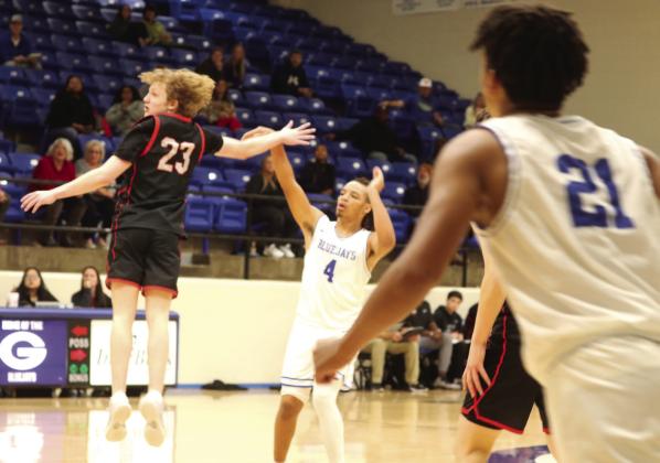 Jaylen Harper takes a shot with Crossings Christian player in face as Aiden Hardamen looks on.