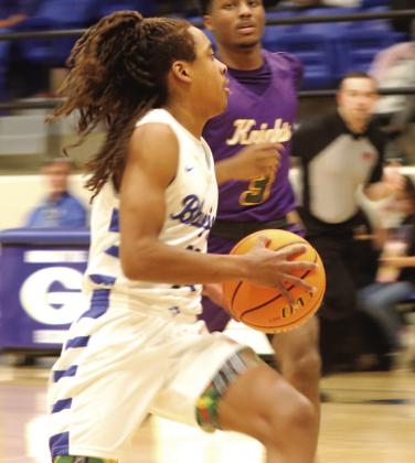 Brayden Morgan heads for basket as Northwest Classen_s Lesley Rose gives chase.