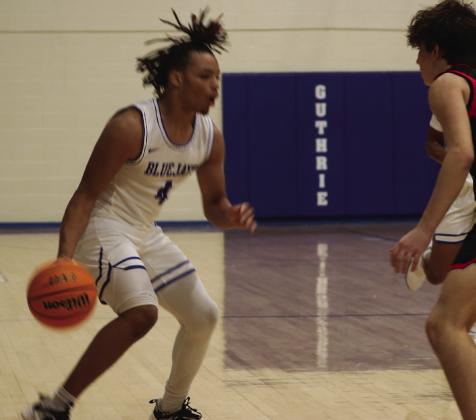Jaylen Harper looks to go to the basket against Crossing Christian player.