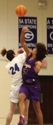 Corbin Witt in jump ball with NWC’s Xzavier Nicholsen. Photos by Mike Monahan