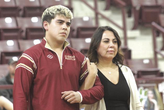 Cashion wrestling senior Kaleb Duran with his family on Senior Night. Photo by George McCormick
