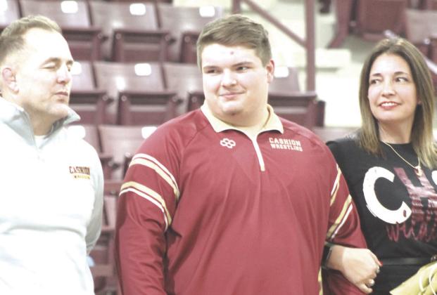 Cashion wrestling senior Matthew Stockton with his family on Senior Night. Photo by George McCormick