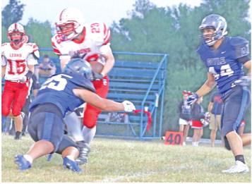 Xavier Amaro moves in on TJ McIntire as Gage Wilks moves in to help and Clayton Kawik looks on. Photos by Mike Monahan