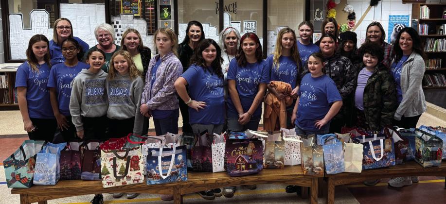 Students and volunteers with completed gift bags for residents of Guthrie Cottages. Photo submitted