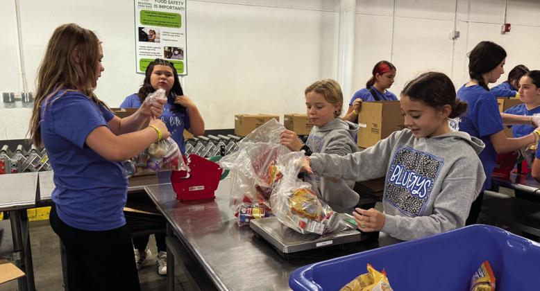 We Speak Life students packing food at the Oklahoma Regional Food Bank. Photo submitted