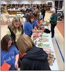 Guthrie Upper Elementary students in the We Speak Life program pack Christmas gifts for residents of Guthrie Cottages, a cozy living facility that provides care for individuals with learning disabilities. Photo submitted