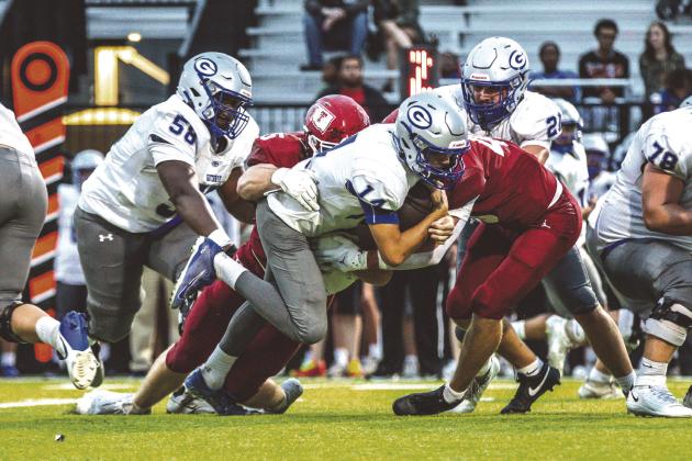 Guthrie quarterback Daelon Rice stretches for extra yardage as Tuttle defenders bring him to the ground. Guthrie players Sir’William Morgan(58) and Owen Wilder (78) are in on the play. Tuttle won 38-13.