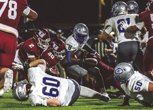 Guthrie Running back Elijah Smith tries to spin away from Tuttle tacklers during the Bluejays’ 38-13 seasoning-opening loss Thursday.