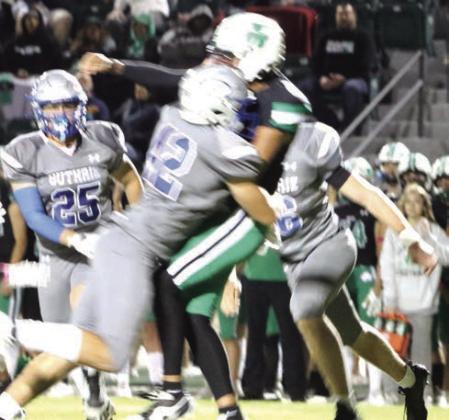 Guthrie Football-Eli Moroney lays a hit on Irish Quarterback Damon Cochran.
