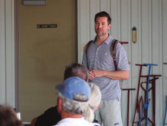 Adam Pugh talking to group of pilots and legislators before flights