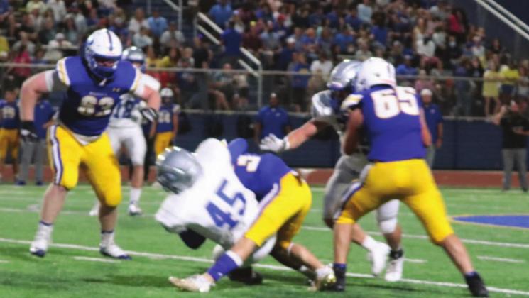 Chris Shaputis wrestles Piedmont runner to the ground