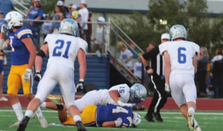 Landen Hirzel sacks the Piemont quarterback as Spade Pool and Jackson Walters move in for support