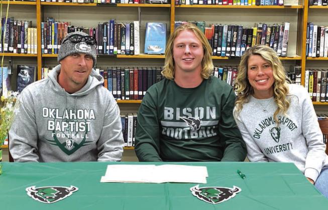 LEFT: Jason Hirzel, Landen Hirzel and Kelly Hirzel at letter of intent signing on Feb. 1 at Guthrie High School. Photo by Chris Evans