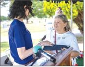 Michele Brown, representing U.S. Rep. Stephanie Bice, presents Patricia Perkins with a replacement veteran’s flag during the Memorial Day ceremony at Summit View Cemetery in Guthrie on Monday. Perkins lost her late husband’s flag in a fire last year.. Photo by Brent Fuchs
