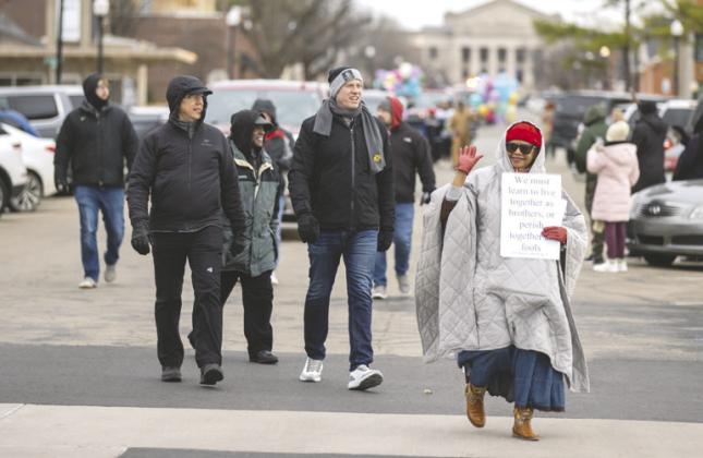 Mayor Adam Ropp walks alongside community members during the annual Martin Luther King Jr. parade in Guthrie. Photo by Brent Fuchs